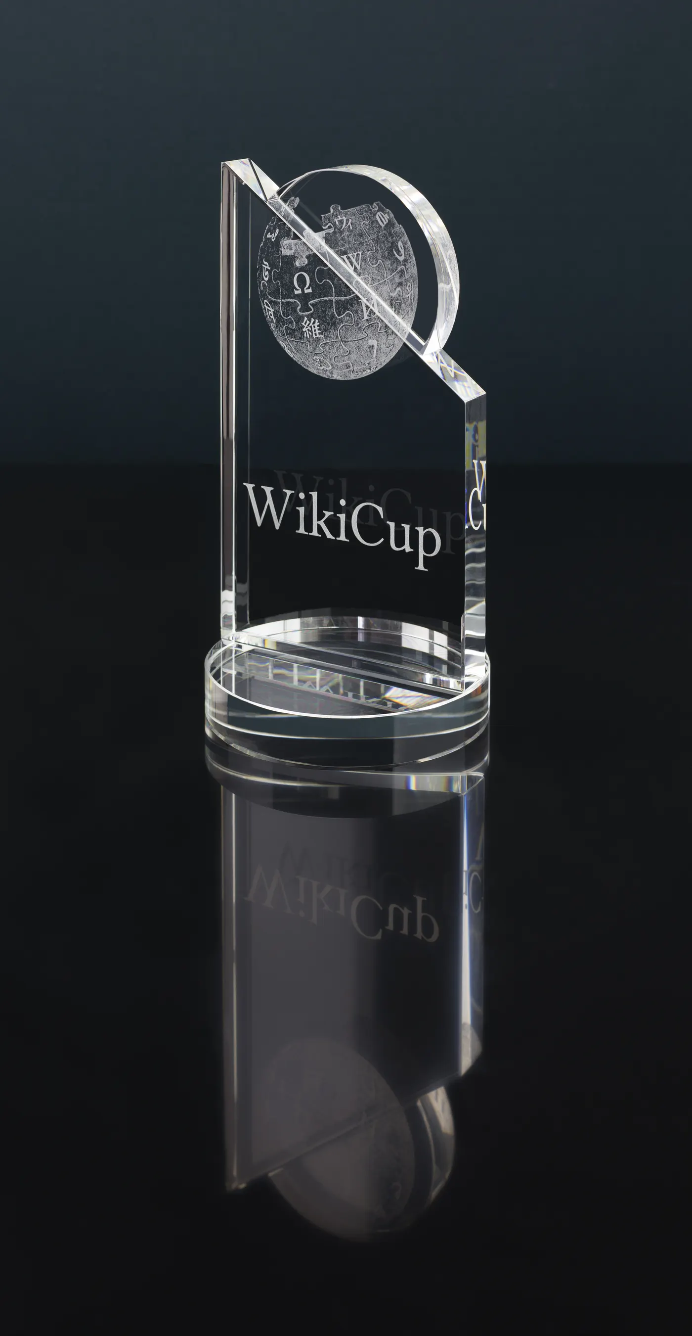 A tall clear acrylic award trophy