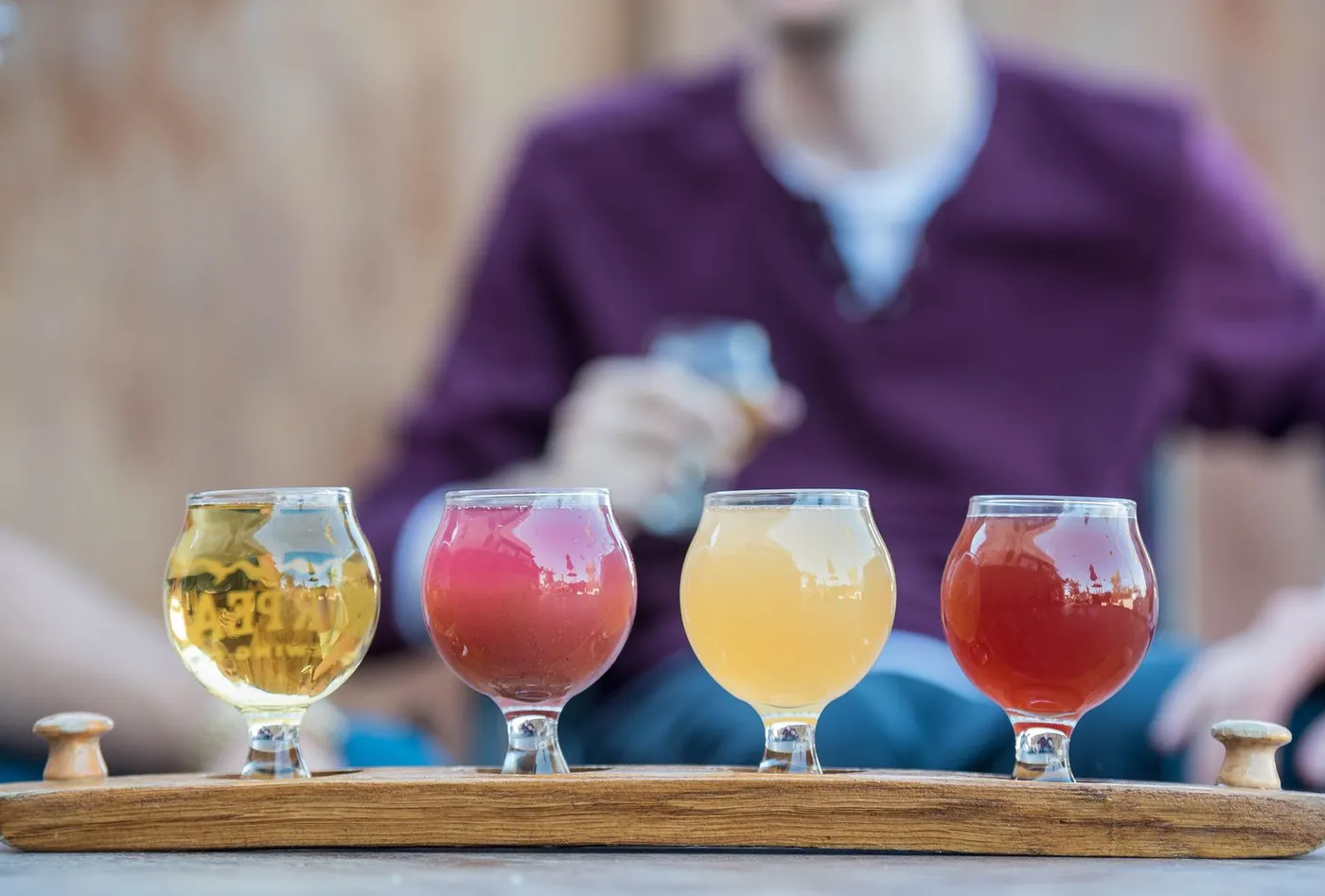 A flight of craft beers in assorted branded glasses
