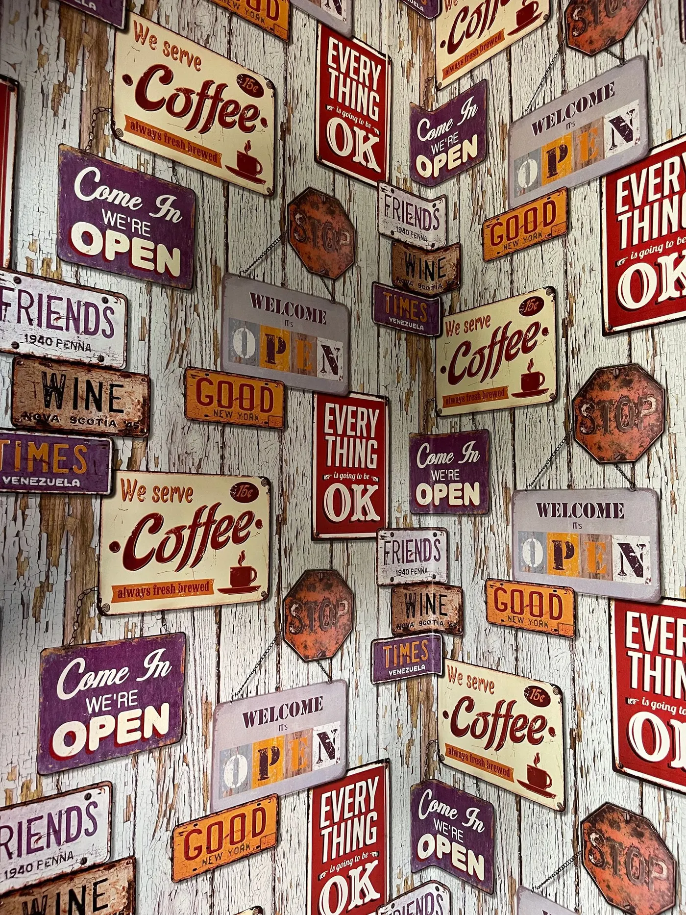 A wall of colorful retro printed tin signs