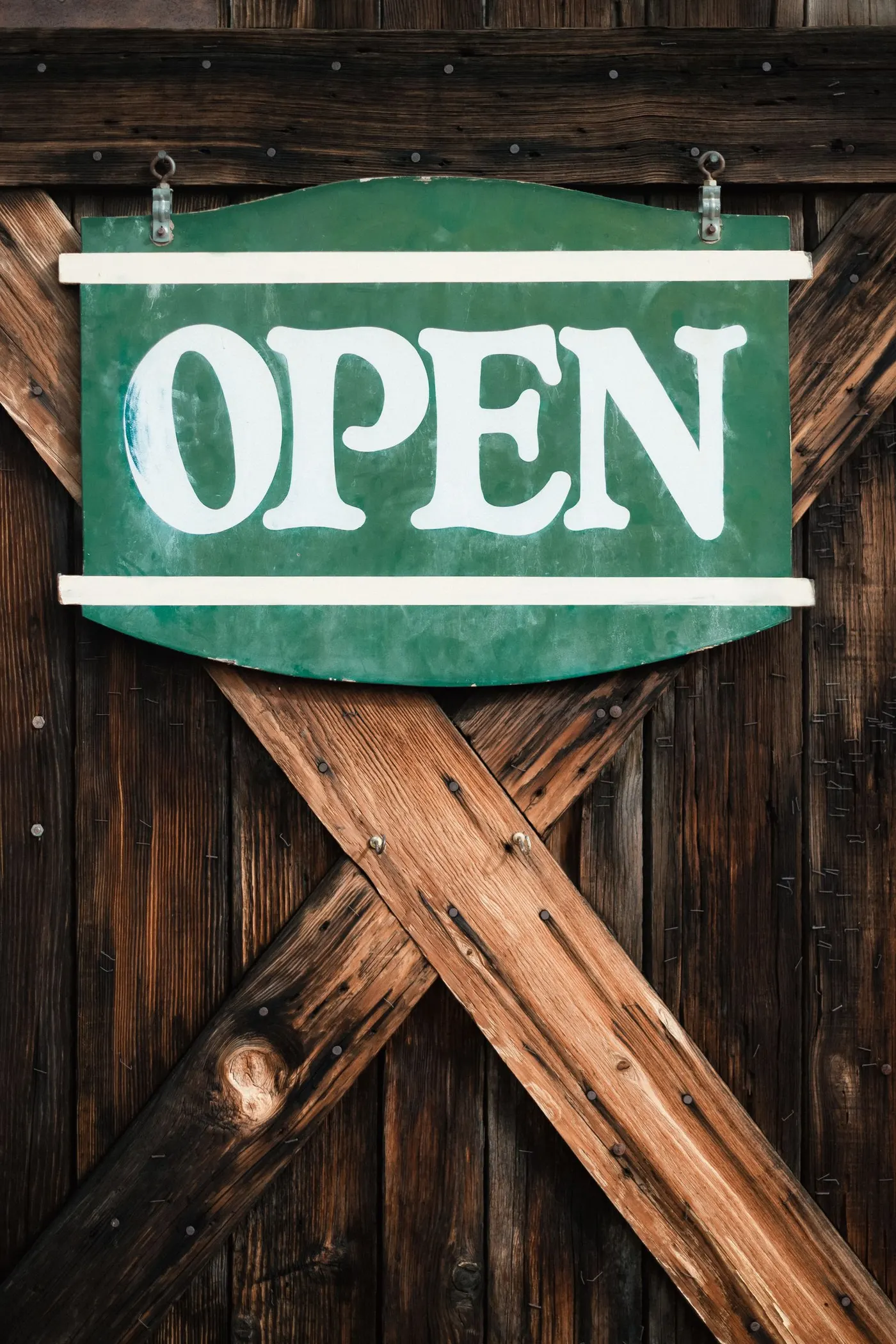 A vintage carved and painted wooden shop sign